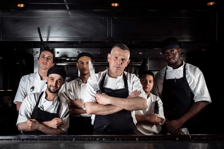 Head chef and his kitchen crew at London restaurant, lifestyle photography