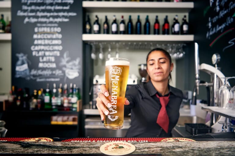 Barista serving a pint of menabrea beer in London, commercial lifestyle photograhy